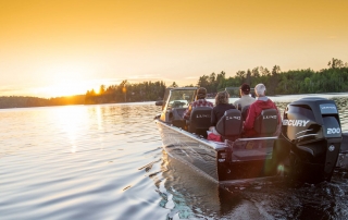 Lund fishing boat on the lake during sunrise